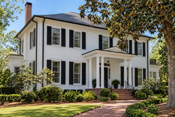 White two-story colonial with black seamless gutters, black downspouts and black shutters